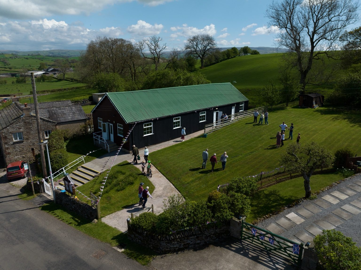 Aerial view of Musgrave Parish Institute and its lawn in the Eden Valley countryside